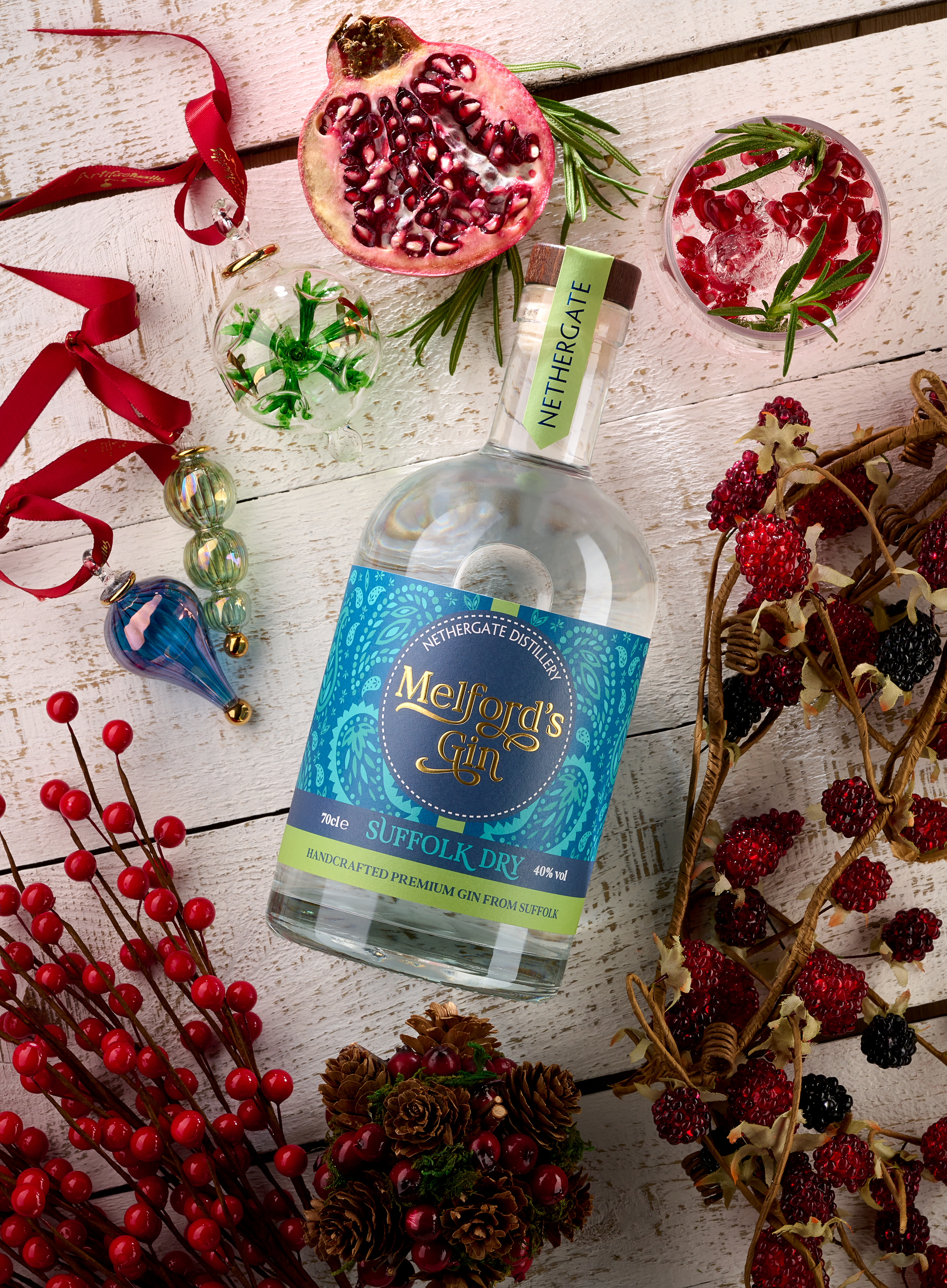 Melford's Gin bottle on a white painted wooden background with Christmas decorations